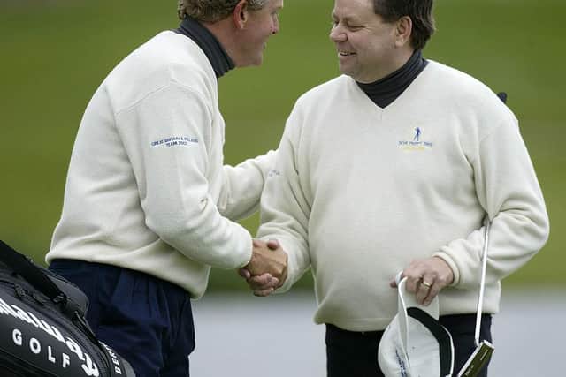 Colin Montgomerie congratulates Andrew Oldcorn after their victory in the afternoon foursomes on day one of the 2002 Seve Trophy at Druids Glen. Picture: Andrew Redington/Getty Images.