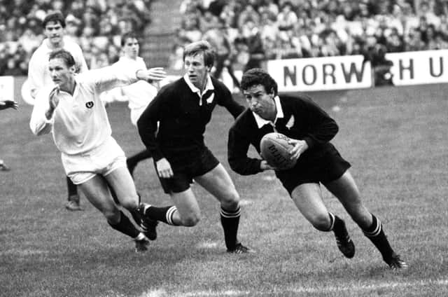 New Zealand's Wayne Smith (right) breaks away with the ball during the 25-25 draw with Scotland in 1983.