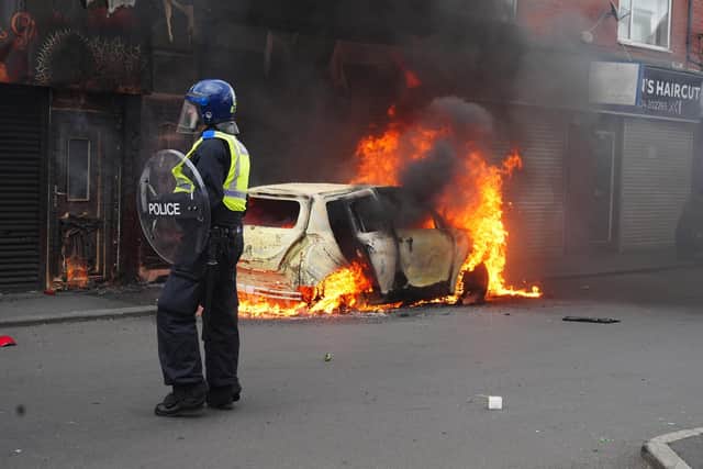 A car burns on Parliament Road, in Middlesbrough, during an anti-immigration riot. Credit: Owen Humphreys/PA Wire