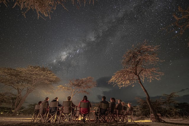One of Paul Goldstein's groups enjoys the night sky and bush TV (the camp fire) at Kicheche Bush Camp, Kenya.