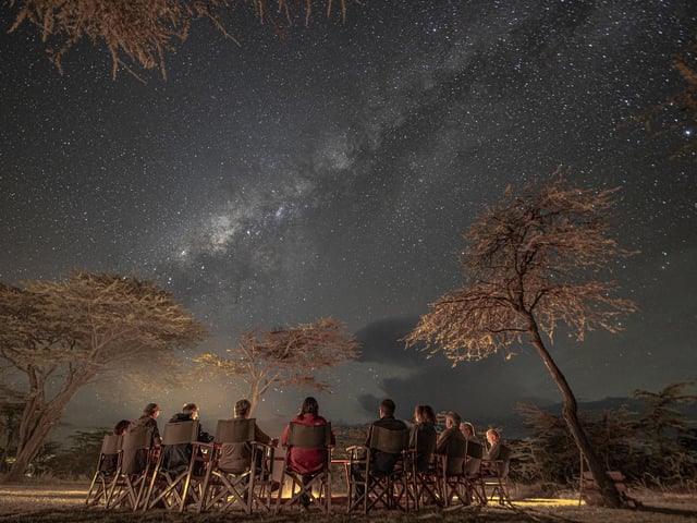 One of Paul Goldstein's groups enjoys the night sky and bush TV (the camp fire) at Kicheche Bush Camp, Kenya.