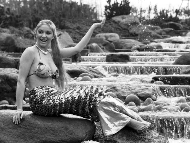 Former Miss Scotland Natalie Devlin dressed as a mermaid beside the OCS-sponsored waterfall at the Glasgow Garden festival site in March 1988.