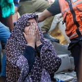 People search buildings destroyed in Israeli air raids in the southern Gaza Strip (Picture: Ahmad Hasaballah/Getty Images)