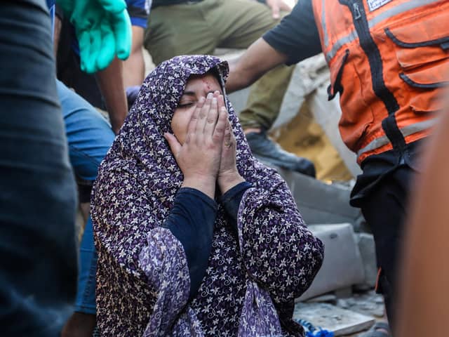People search buildings destroyed in Israeli air raids in the southern Gaza Strip (Picture: Ahmad Hasaballah/Getty Images)