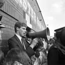 A policeman watches as Shareholders' Association chairman Ewan Stewart addresses the hundreds of angry Hibs fans who turned up at Easter Road football stadium after hearing Hearts chairman Wallace Mercer planned a takeover of their club in June 1990.