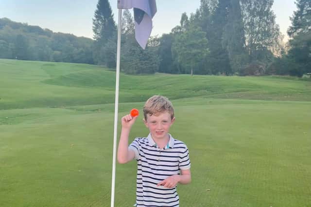 Six-year-old Harris Inglis proudly shows off the ball he hit for his hole-in-one at Callander.