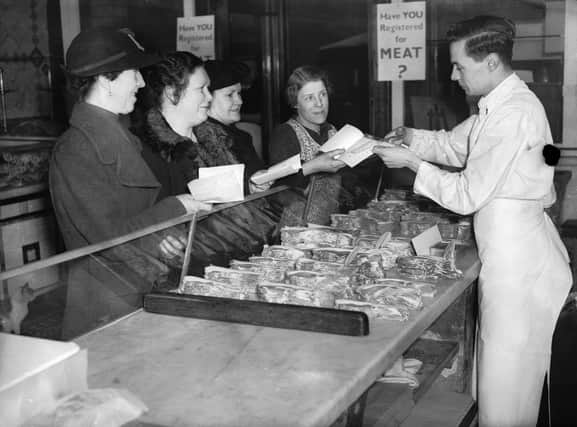 Shoppers queue for meat in 1940, when food rationing was in force - and people were healthier than they are today (Picture: Reg Speller/Fox Photos/Getty Images)