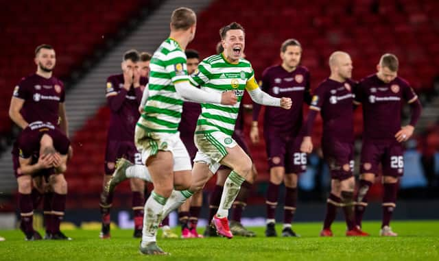 Celtic players celebrate with distraught Hearts in the background.