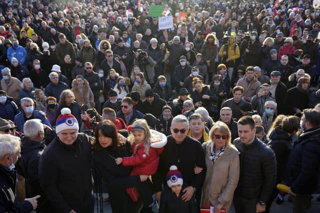 Serbia's Novak Djokovic's father Srdjan, front center, mother Dijana, second right, and brother Djordje, right, pose after protest in Belgrade, Serbia on Friday.