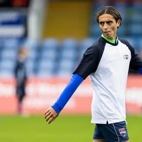 Ross County's Yan Dhanda warms up ahead of kick-off against Hibs on Saturday. (Photo by Ross Parker / SNS Group)