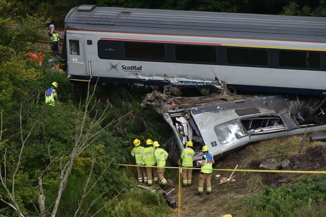 Members of the emergency services inspect the debris and derailed carriages at the scene of the train crash near Stonehaven in north-east Scotland on August 12, 2020. Picture: Ben Birchall/POOL/AFP via Getty Images