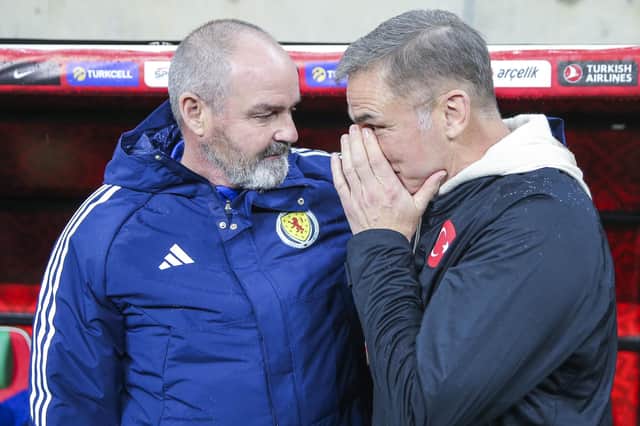 Scotland's head coach Steve Clarke, left, talks to Turkey' counterpart Stefan Kuntz prior the kick-off at the Diyarbakir Stadium. (AP Photo)