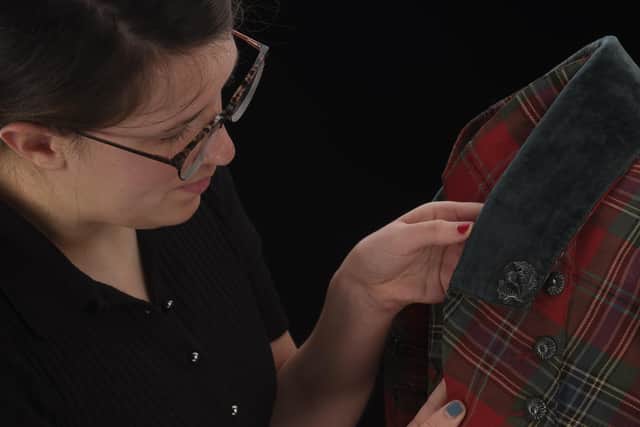 Dr Rosie Waine, who has led the new research into the history of Highland dress, with a 19th century tartan suit. Picture: National Museums Scotland