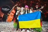 Members of the band "Kalush Orchestra" pose onstage with the winner's trophy and Ukraine's flags after winning on behalf of Ukraine the Eurovision Song contest in Turin. (Photo by Marco BERTORELLO / AFP) (Photo by MARCO BERTORELLO/AFP via Getty Images)