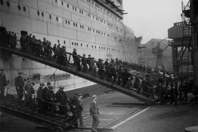 Some of the hundreds of workers employed on the construction of the Cunard liner Queen Mary at John Brown's shipyard, Clydebank, leaving the vessel at lunchtime, circa 1935 (Picture: General Photographic Agency/Getty Images)