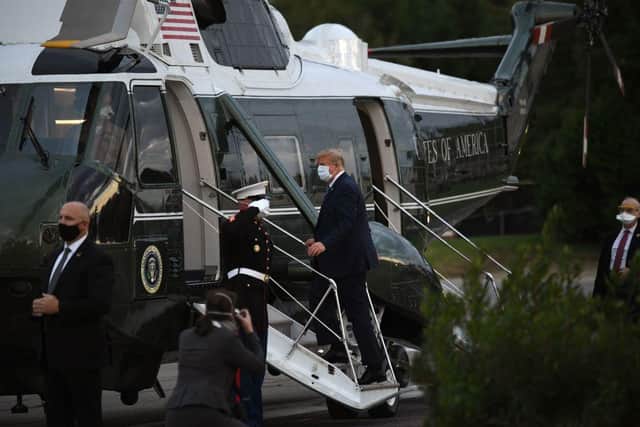 US President Donald Trump leaves Walter Reed Medical Center in Bethesda, Maryland boarding Marine One on October 5, 2020, to return to the White House after being discharged. (Photo by SAUL LOEB/AFP via Getty Images)