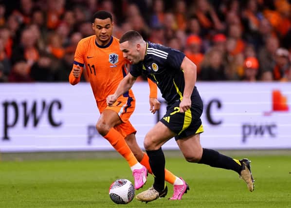Scotland's John McGinn looks for a way past Netherlands' Cody Gakpo during an international friendly match at the Johan Cruyff Arena, Amsterdam.