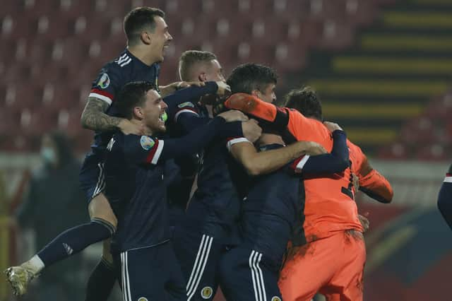 Scotland players celebrate their victory in the Euro 2020 playoff final soccer match between Serbia and Scotland, at the Rajko Mitic stadium in Belgrade, Serbia, Thursday, Nov. 12, 2020. (AP Photo/Darko Vojinovic)