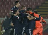Scotland players celebrate their victory in the Euro 2020 playoff final soccer match between Serbia and Scotland, at the Rajko Mitic stadium in Belgrade, Serbia, Thursday, Nov. 12, 2020. (AP Photo/Darko Vojinovic)