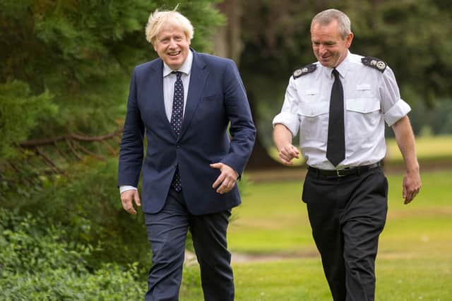 Prime Minister Boris Johnson, accompanied by Chief Constable Iain Livingstone, prepares to meet officers during a visit to the Scottish Police College at Tulliallan on Wednesday