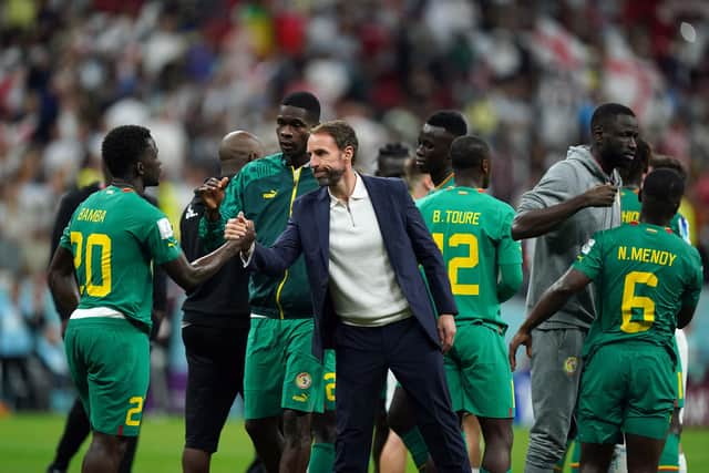 England manager Gareth Southgate consoles the Senegal players.