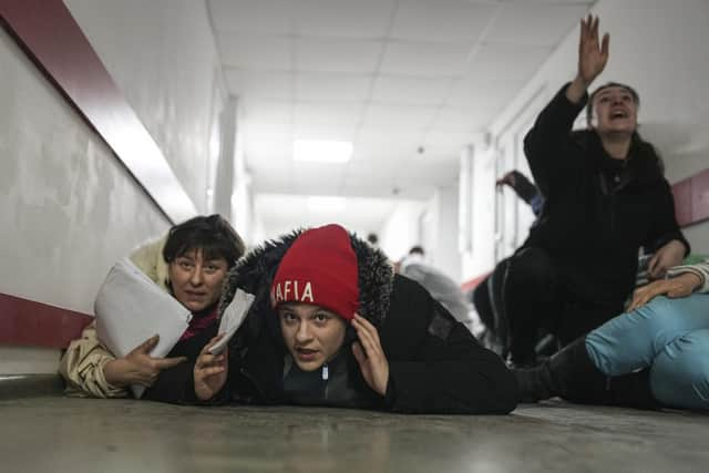 People lie on the floor of a hospital during shelling by Russian forces in Mariupol, Ukraine, Friday, March 4, 2022. (AP Photo/Evgeniy Maloletka)