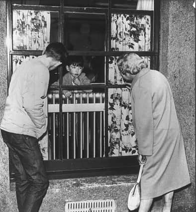 A young victim of Aberdeen's typhoid epidemic speaks to his granny through a hospital window. PIC: Aberdeen Journals.