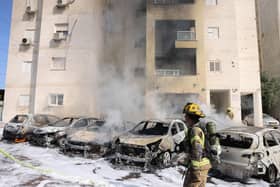 Israeli emergency responders cordon off the site of a rocket attack in the southern Israeli city of Ashdod on  (Photo by AHMAD GHARABLI/AFP via Getty Images)