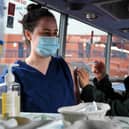 Cheryl Barr of the Scottish Ambulance Service, gives Fiona Douglas, 26, a vet from Falkirk, an injection of a Covid-19 vaccine on the Scottish Ambulance Service vaccine bus in Glasgow on July 28, 2021. Photo by ANDY BUCHANAN/AFP via Getty Images