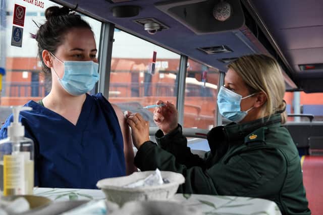 Cheryl Barr of the Scottish Ambulance Service, gives Fiona Douglas, 26, a vet from Falkirk, an injection of a Covid-19 vaccine on the Scottish Ambulance Service vaccine bus in Glasgow on July 28, 2021. Photo by ANDY BUCHANAN/AFP via Getty Images