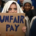 A demonstrator holds a placard during a protest by junior doctors (Picture: Daniel Leal/AFP via Getty Images)