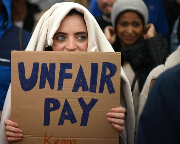 A demonstrator holds a placard during a protest by junior doctors (Picture: Daniel Leal/AFP via Getty Images)