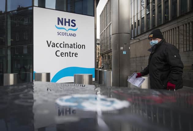 A member of the public outside the main entrance to the coronavirus mass vaccine centre at the Edinburgh International Conference Centre. Picture date: Monday February 1, 2021.
