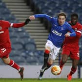 Rangers' Scottish midfielder Scott Wright (C) is fouled by Antwerp's Ghanaian midfielder Nana Opoku Ampomah (R) for their second penalty, leading to their fifth goal during the UEFA Europa League Round of 32, 2nd leg (Photo by RUSSELL CHEYNE/POOL/AFP via Getty Images)