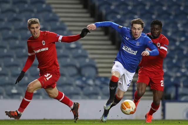 Rangers' Scottish midfielder Scott Wright (C) is fouled by Antwerp's Ghanaian midfielder Nana Opoku Ampomah (R) for their second penalty, leading to their fifth goal during the UEFA Europa League Round of 32, 2nd leg (Photo by RUSSELL CHEYNE/POOL/AFP via Getty Images)