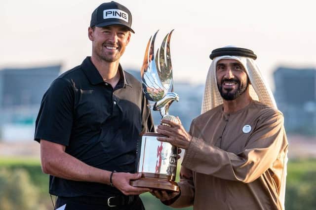 Dundee-based Frenchman Victor Perez receives the trophy from Sheikh Nahyan bin Zayed Al Nahyan, chairman of Abu Dhabi Sports Council, after winning the Abu Dhabi HSBC Championship at Yas Links. Picture: Picture: Ryan Lim/AFP via Getty Images.
