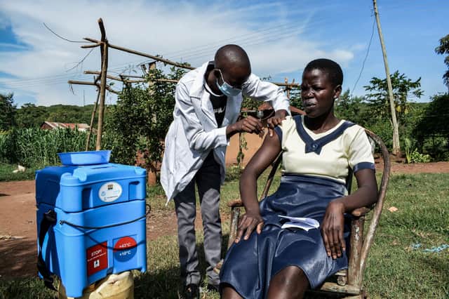 A health worker vaccinates a woman against Covid in Siaya, Kenya. But just 11 per cent of people in Africa have been immunised (Picture: Brian Ongoro/AFP via Getty Images)