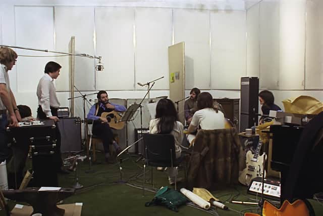 Paul leads the Fab Four through another studio session with Yoko Ono back to camera next to John
