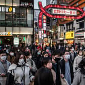 Pedestrians cross a street in Tokyo's Shinjuku area. Picture: AFP via Getty Images
