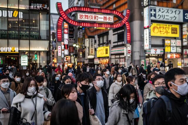 Pedestrians cross a street in Tokyo's Shinjuku area. Picture: AFP via Getty Images