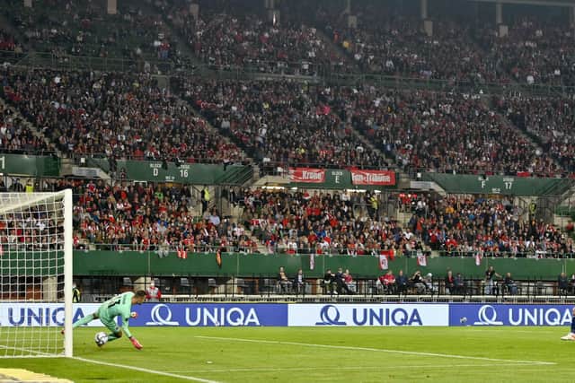 Lyndon Dykes fires home Scotland's penalty in Vienna.