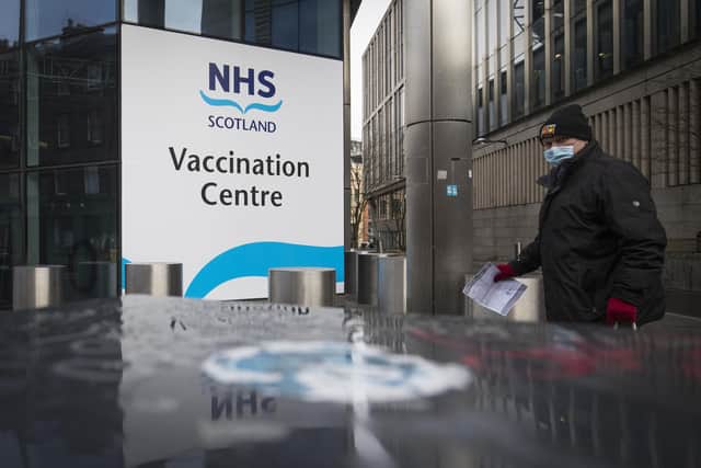 A member of the public outside the main entrance to the coronavirus mass vaccine centre at the Edinburgh International Conference Centre. Picture date: Monday February 1, 2021.