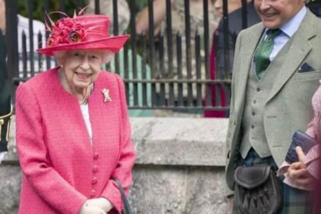 Sandy Manson, the Lord Lieutenant of Aberdeenshire, the King's representative in the area, pictured next to Elizabeth II. PIC: Contributed.