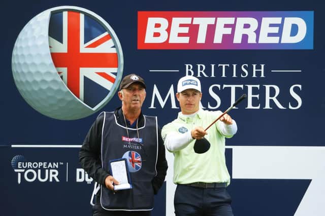 Calum Hill picks a line with caddie Phil "Wobbly" Morbey on the 17th hole during the first round of The Betfred British Masters hosted by Danny Willett at The Belfry. Picture: Andrew Redington/Getty Images.