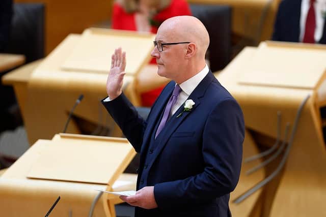 John Swinney is sworn in during the first meeting of the new Scottish Parliament on May 14 2026 in Edinburgh (Picture: Jeff J Mitchell/Getty Images)