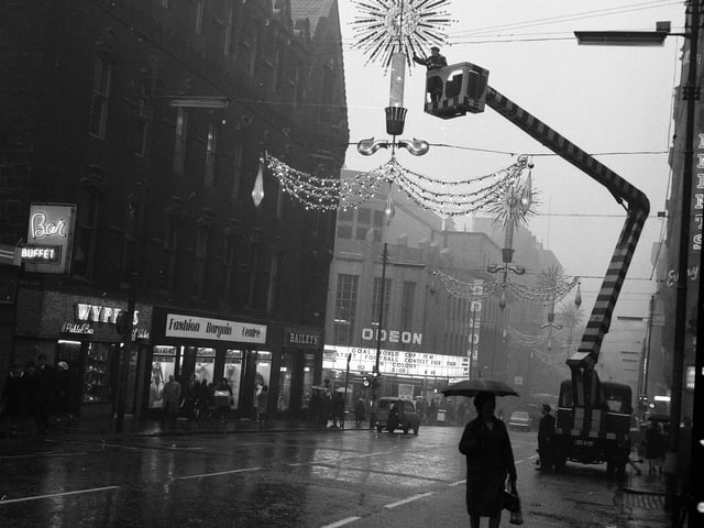 Glasgow Corporation workmen prepare the Christmas lights in the city's Renfield Street in 1963.