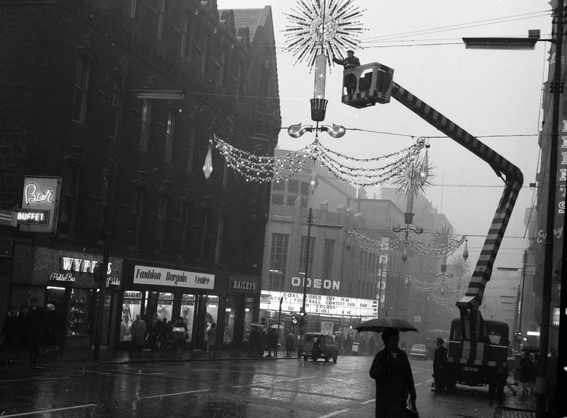 Glasgow Corporation workmen prepare the Christmas lights in the city's Renfield Street in 1963.