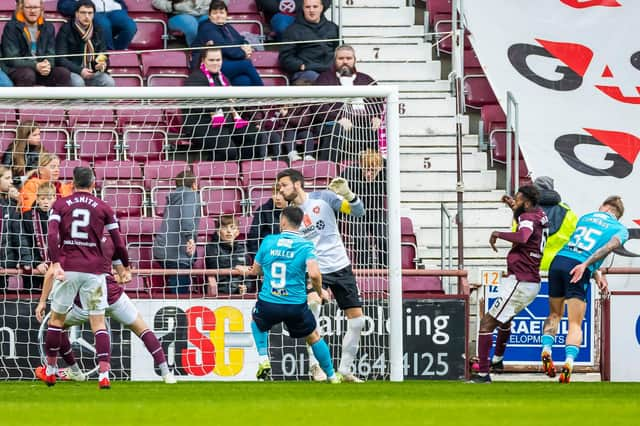 Jason Cummings glances a header home to level the scores for Dundee.