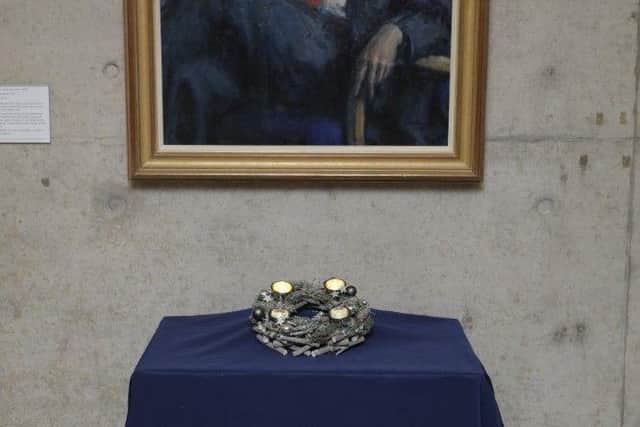 The Advent wreath on display beneath a portrait of devolved Scotland's founding First Minister Donald Dewar MSP.