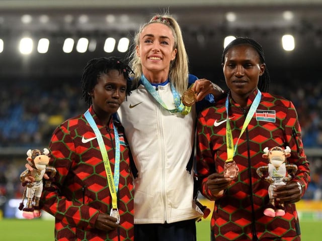 Eilish McColgan on the podium after her 10,000m triumph, flanked by silver medalist Irine Chepet Cheptai and bronze medalist Sheila Chepkirui Kiprotich, both of Team Kenya.